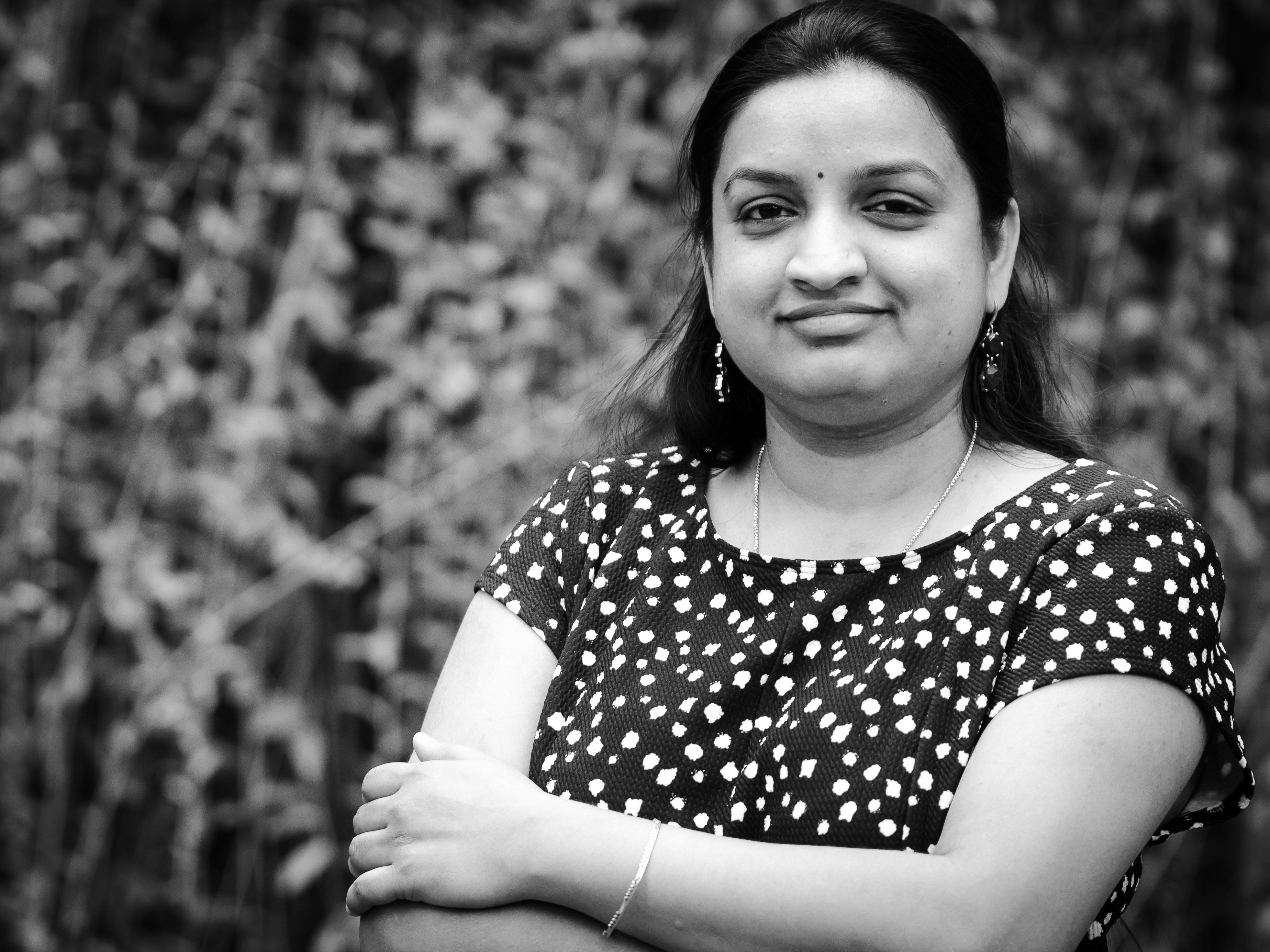 Gayatri Pothukuchi smiling in a black and white image with dotted dress